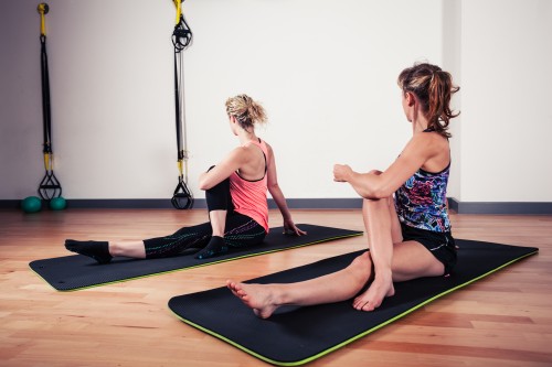 Women stretching their backs in gym