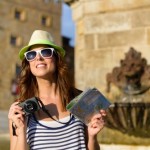 Female tourist with camera and guide map sightseeing